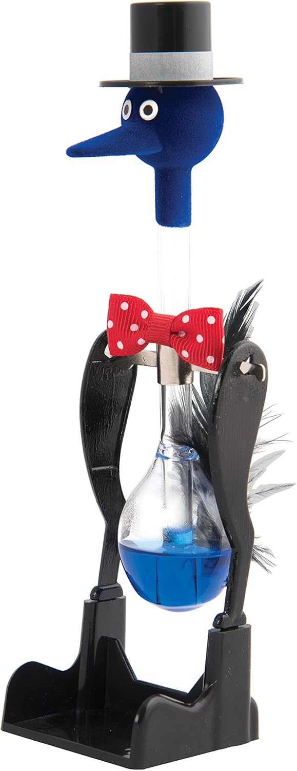 Blue fuzzy-headed bird toy with a top hat, red bowtie, and blue liquid inside a glass body on a black stand.
