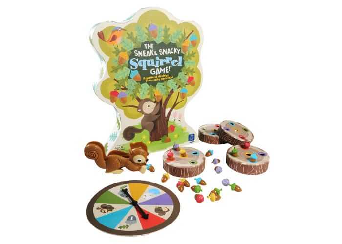 Tree-shaped box with a squirrel squeezer, colorful acorns, four log game boards, and a round spinner.