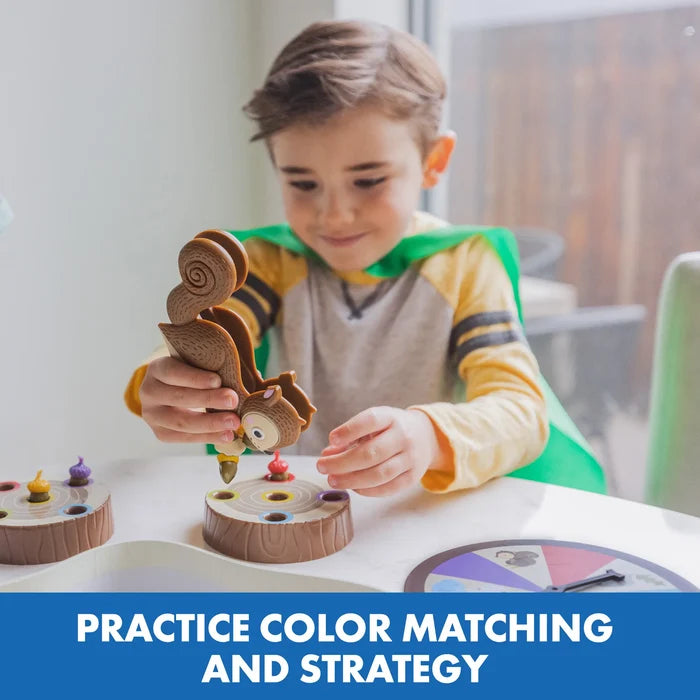 Child uses a squirrel-shaped squeezer to place a colored acorn into a matching hole in a log game board.