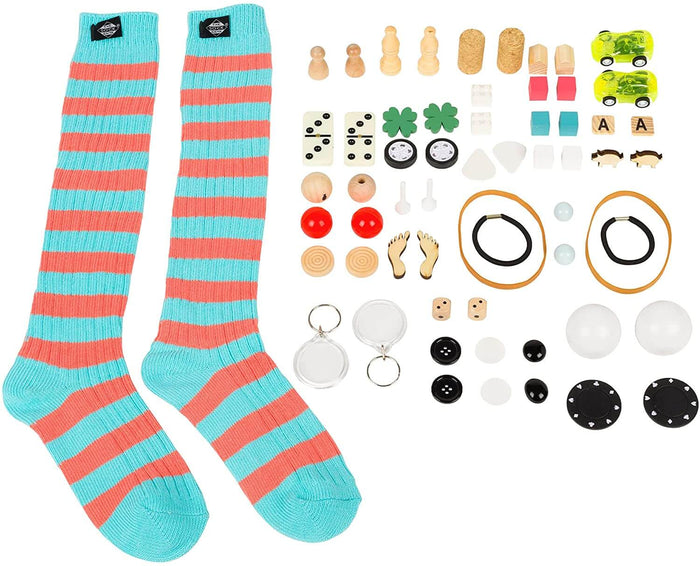 Blue and coral striped socks alongside various small game components like dice, dominoes, and wooden figurines.