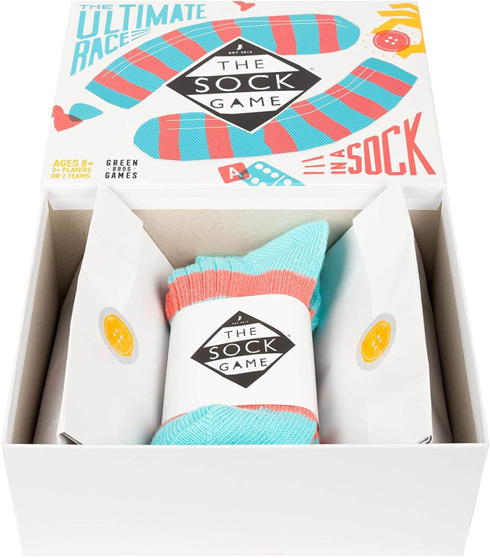 Open board game box showing a turquoise and coral striped knit sock wrapped in a branded white paper band.