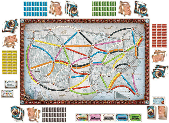 North America map game board with colorful train routes, plastic train pieces, and decks of illustrated playing cards.