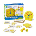 Yellow analog clock, time-matching puzzle cards, and foam dice from a Learning Resources educational set.
