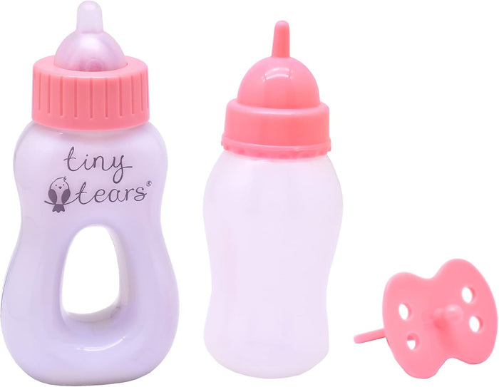 Purple toy bottle with handle, translucent white bottle, and pink doll pacifier, all with pink caps and nipples.