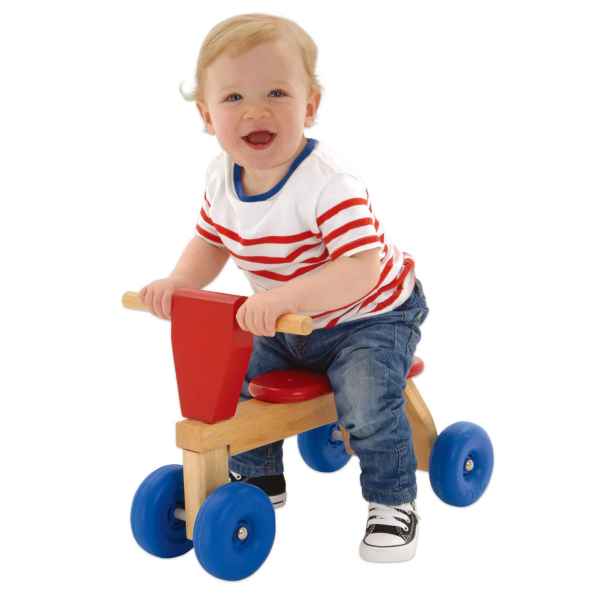 Toddler on a wooden ride-on toy with four blue wheels, red seat, and red front panel.