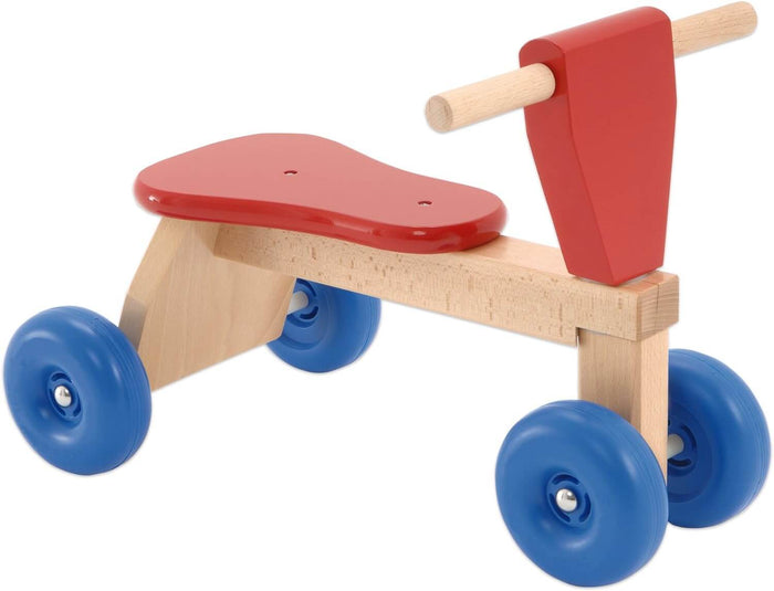 Wooden four-wheeled ride-on toy with a red seat, red steering head, natural wood frame, and blue wheels.