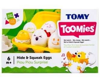 Tomy Toomies toy box featuring a yellow carton of six white plastic eggs with different cartoon facial expressions.
