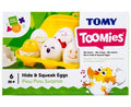 Tomy Toomies toy box featuring a yellow carton of six white plastic eggs with different cartoon facial expressions.