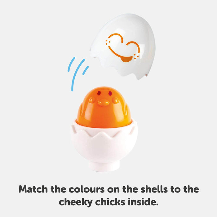 Orange toy chick inside a white plastic egg with its matching orange winking face shell lid lifted off.