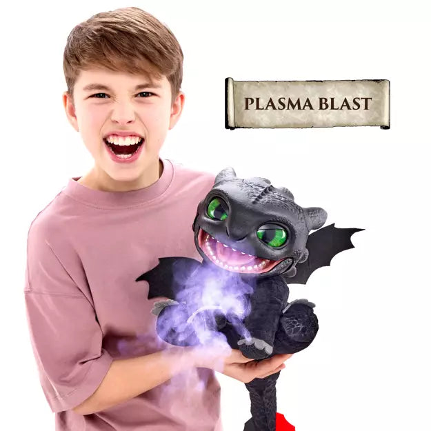 A boy holds a black Toothless dragon toy that emits glowing purple mist from its mouth under a Plasma Blast label.