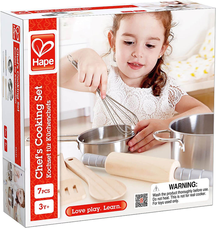 White and red box for a 7-piece toy set showing a girl using stainless steel pans, a metal whisk, and wooden tools.