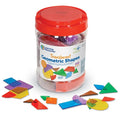 Colorful, translucent plastic geometric shapes scattered around a clear storage tub with a red lid.