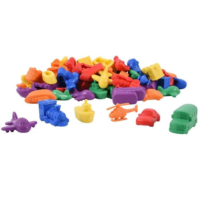 Colorful plastic toy transport shapes including planes, trains, boats, helicopters, cars, and buses in a pile.