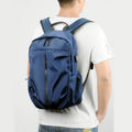 Blue travel backpack with USB charging port and water-resistant design, designed for laptops and travel convenience.