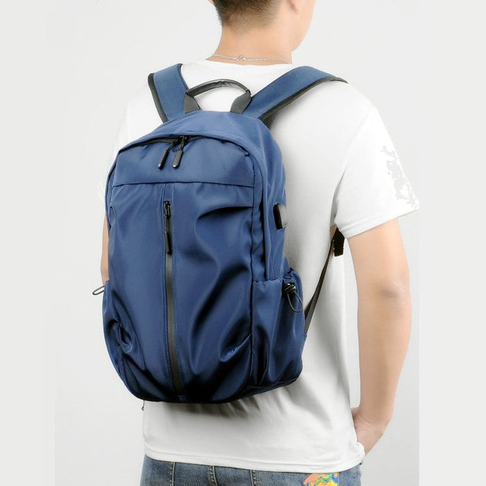 Blue travel backpack with USB charging port and water-resistant design, designed for laptops and travel convenience.