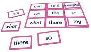 Pink 3x3 word bingo grid with white word cards and loose matching cards for we, what, there, and so.