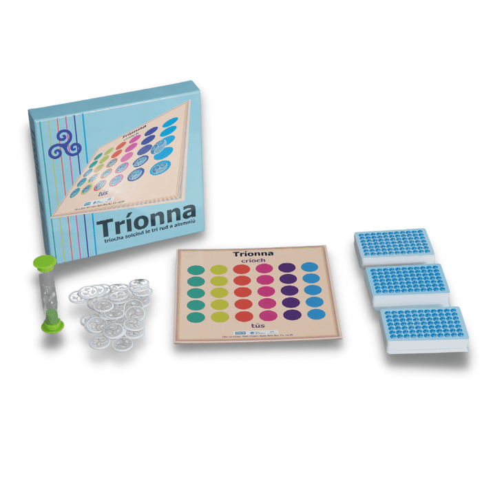 Light blue board game box, board with colorful circle grid, green sand timer, white tokens, and three stacks of cards.