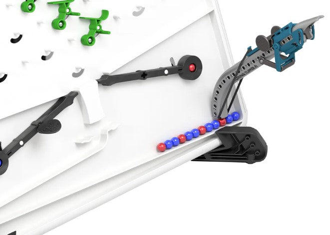 Blue mechanical reloader and gray track on a white board with red and blue marbles, black levers, and green parts.