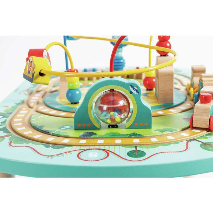 Wooden activity table with a yellow wire maze, train tracks, and a green arch with a clear spinning ball of beads.