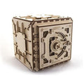 Light wood cube-shaped mechanical safe with a circular combination dial, interlocking puzzle joints, and visible gears.