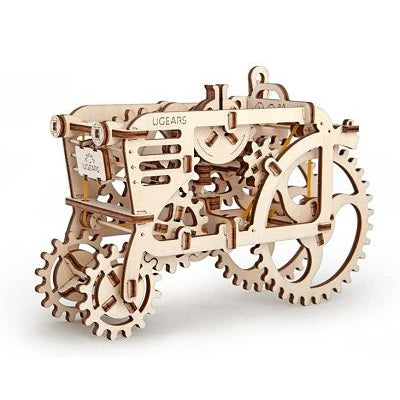 Intricate light-wood 3D mechanical tractor puzzle featuring large gear wheels and visible inner clockwork mechanisms.