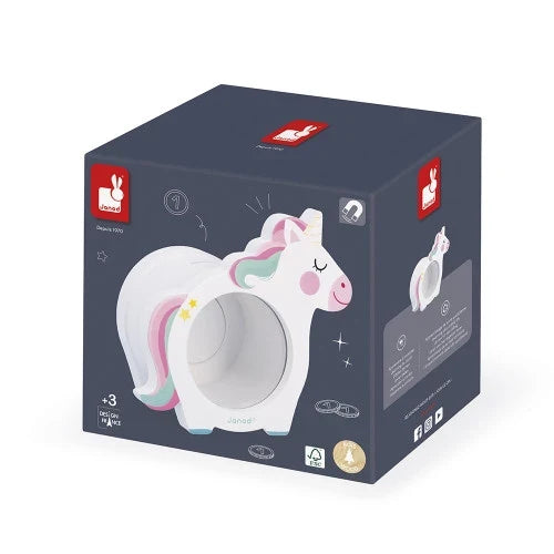 Dark grey cubic box showing Janod's white wooden unicorn money box with a rainbow mane and clear circular window.