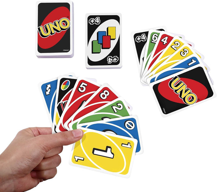 Hand holding a fan of colorful Uno cards near a deck and a Wild Draw 4 card on a white background.
