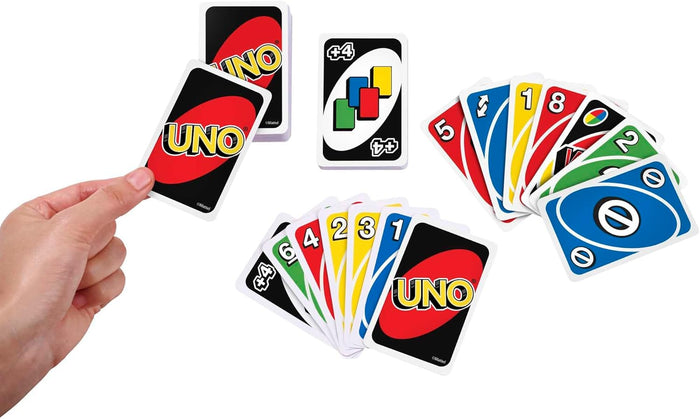 Hand holding a card next to fanned out red, blue, yellow, and green Uno cards and a central Wild Draw 4 card.