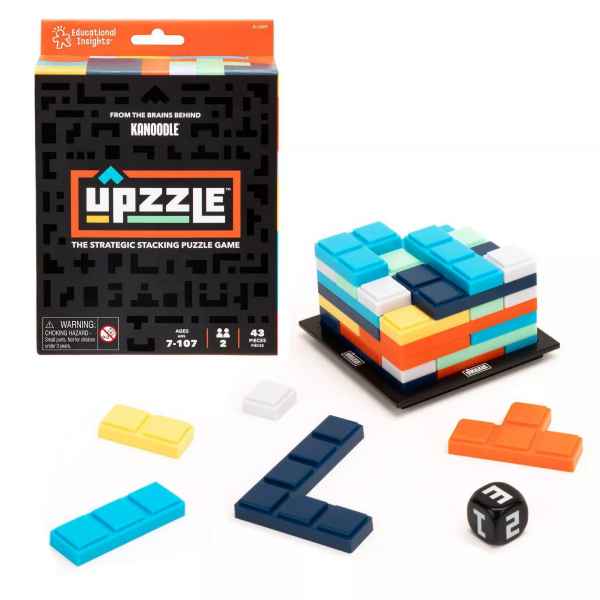 Black game box next to colorful plastic blocks stacked on a base with loose pieces and a black die.