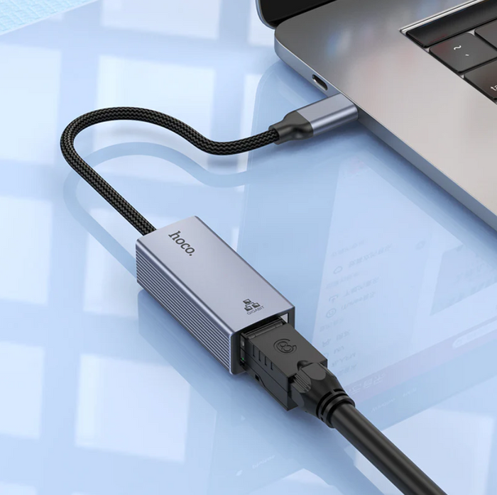 Techplus USB-C to RJ45 Ethernet adapter connected to a laptop, showing a 1000Mbps gigabit LAN port for fast wired internet.
