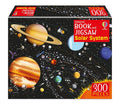 Solar system jigsaw box showing colorful planets and space probes on a black background with a red 300 pieces label.