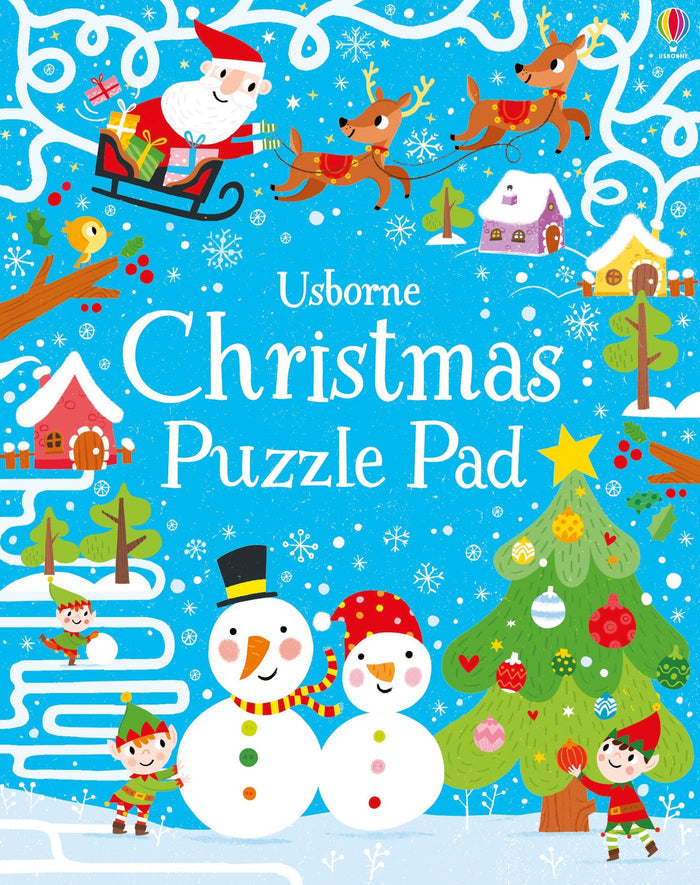 Bright blue cover featuring Santa, reindeer, snowmen, and elves in a snowy, festive winter landscape.