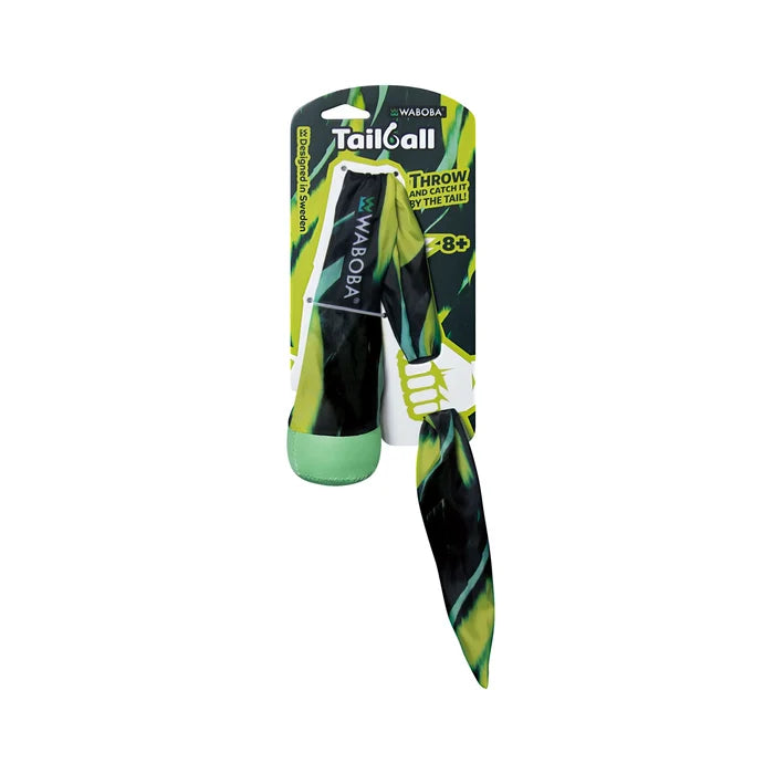 Soft lime green and black patterned ball with a long matching fabric tail, attached to a cardboard display card.