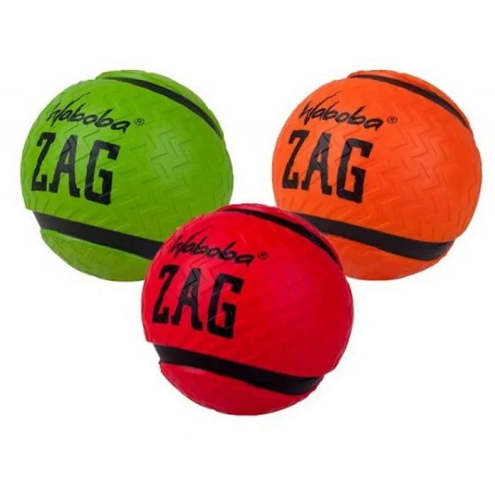 Three textured balls in green, orange, and red with a zig-zag pattern and black bands, labeled Waboba Zag.