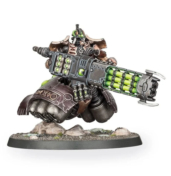 Bronze and silver robotic figure hovering on rocks, wielding a massive glowing green multi-barrel energy weapon.