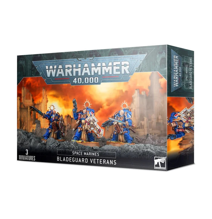 Box art of three blue-armored Space Marines with gold trim, shields, and swords against a fiery battlefield backdrop.