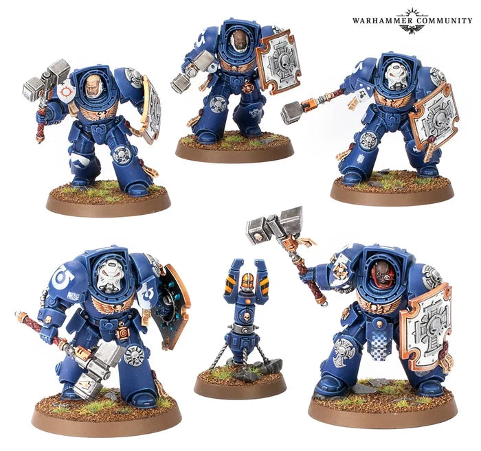 Five blue Space Marine Terminator miniatures with thunder hammers and storm shields, plus a small homing beacon.