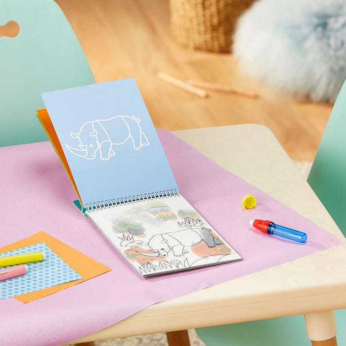 Spiral-bound safari activity book open to a rhino drawing with a blue water pen on a purple craft surface.