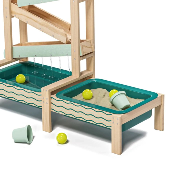 Multi-level wooden water toy with teal basins for sand and water play, cascading water, yellow balls, and mint cups.