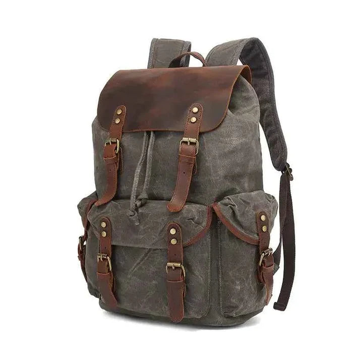 Black waxed canvas computer travel bag with leather accents, Mead's Supply & Equipment Outfitters 20-35L laptop backpack for work and school.