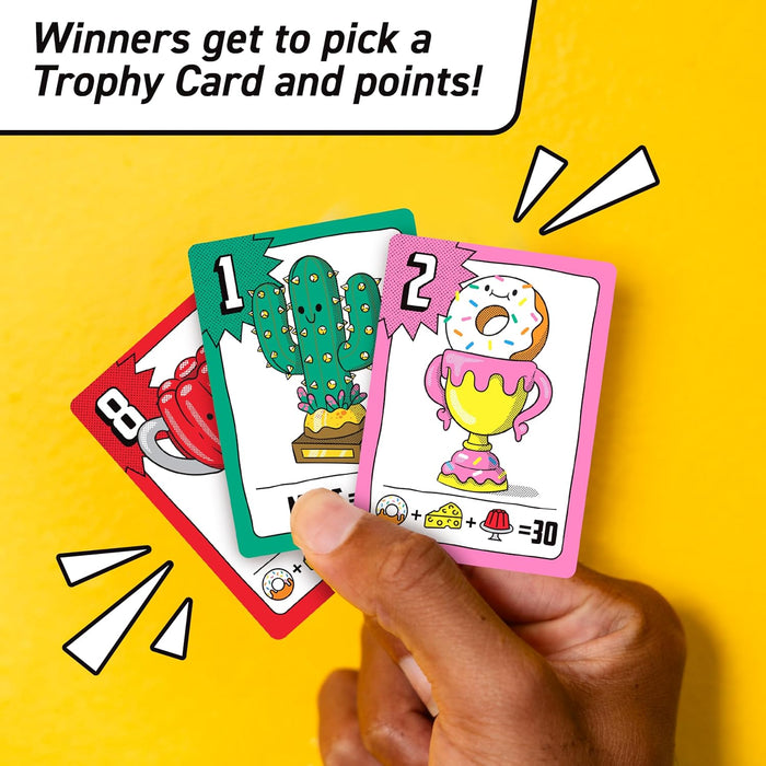 Hand holding three colorful game cards with illustrations of a cactus and a donut against a yellow background.
