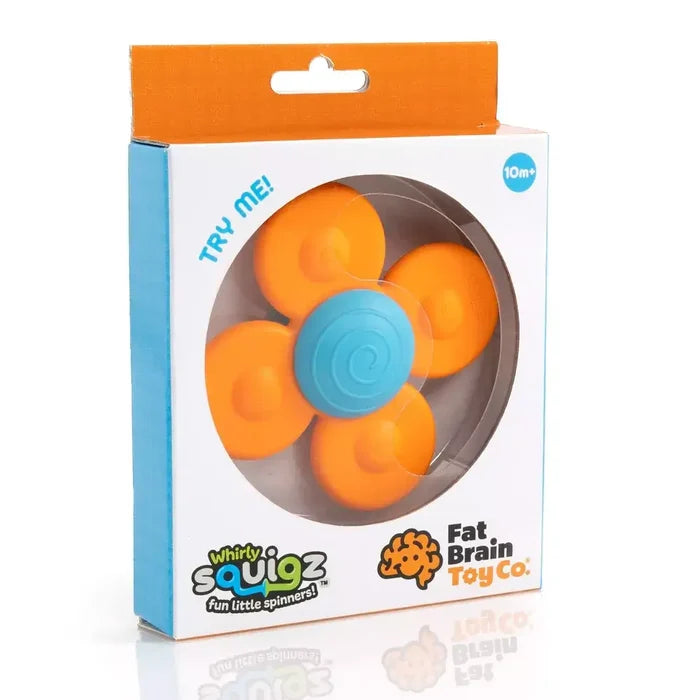 Orange four-petaled toy spinner with a blue spiral suction cup center inside a white retail box with a window.