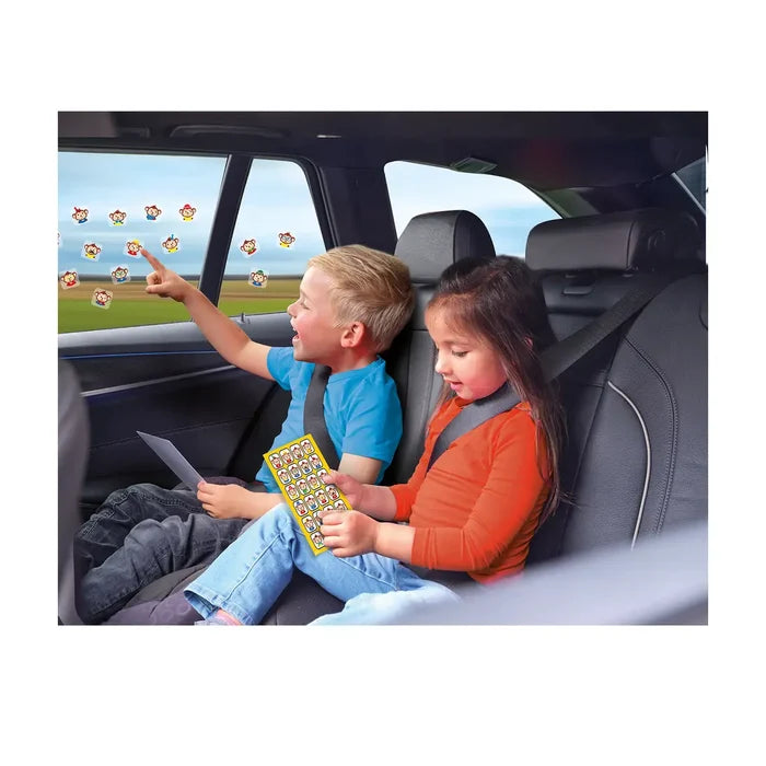 Boy and girl in a car playing with colorful monkey window stickers on glass and from a yellow sticker sheet.