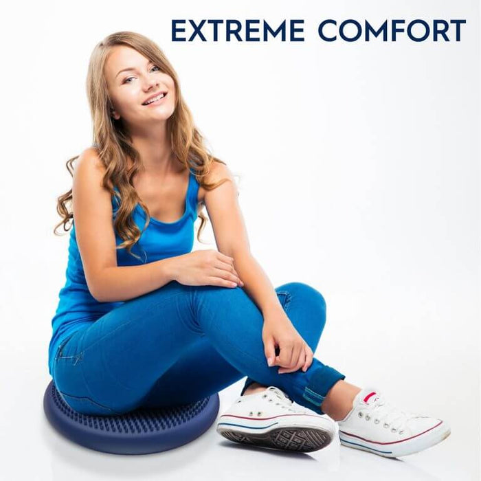 Woman sitting on a blue, textured disc-shaped sensory cushion. Text: EXTREME COMFORT.