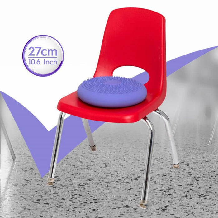 Purple 27cm disc-shaped sensory wiggle cushion with soft spikes sitting on a red plastic school chair.
