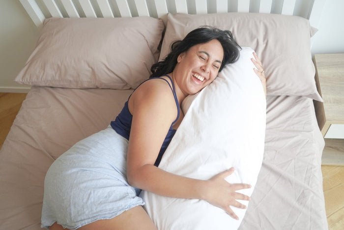 Do Not Disturb Sleep Company Wisewool™ Body Pillow showing soft, plush fabric and ergonomic shape for comfortable sleep support.