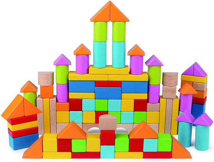 A tall toy castle built with colorful wooden blocks in geometric shapes like cylinders, triangles, and cubes.