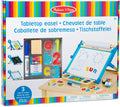 Blue tabletop easel toy set box featuring a paper roll, magnets, and art supplies against rainbow stripes.