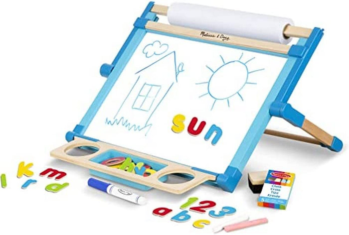 Blue wooden tabletop easel with a paper roll, drawings, magnetic letters, numbers, and various art supplies.