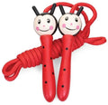 Red ladybug skipping rope with smiling wooden handles, black polka dots, and a thick red coiled rope.